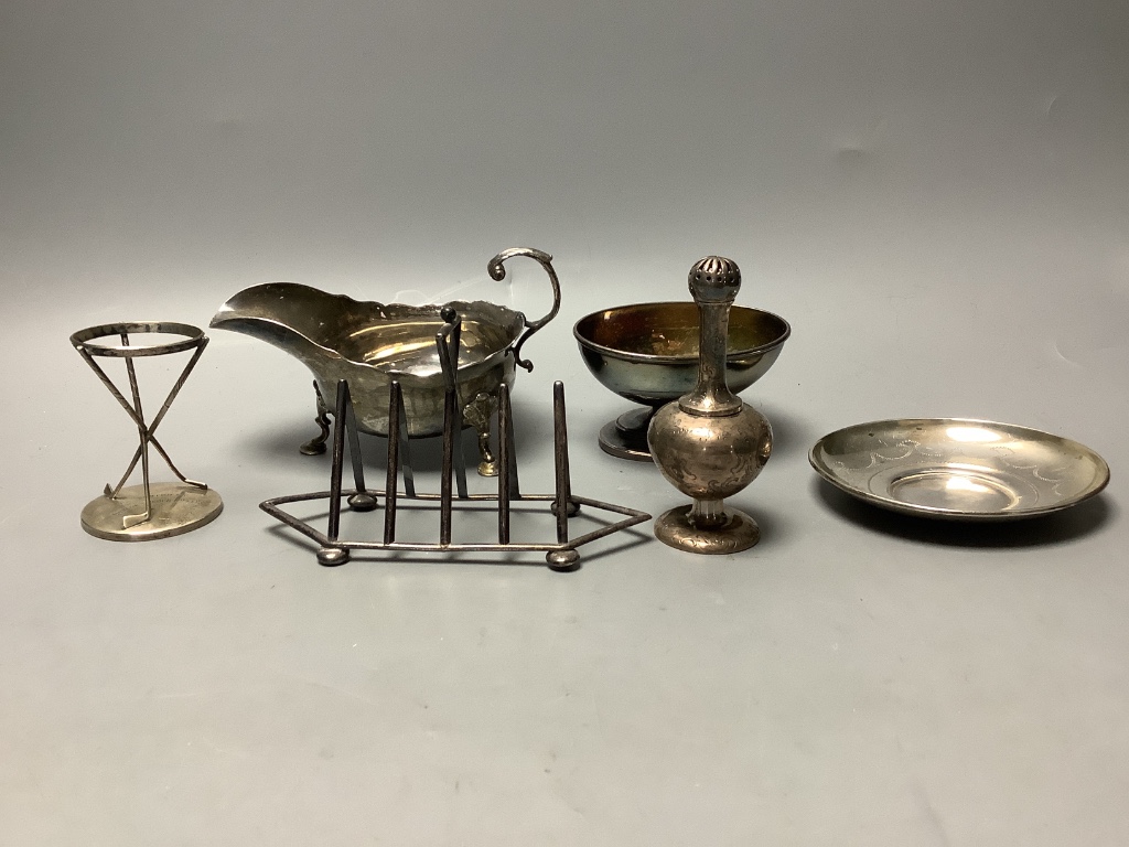 A group of 18th century and later silver, including a George III Newcastle sauceboat, by John Langlands and cream jug, later condiment set, Victorian toastrack, trophy, salts bottle, salt, rosewater sprinkler etc. some a